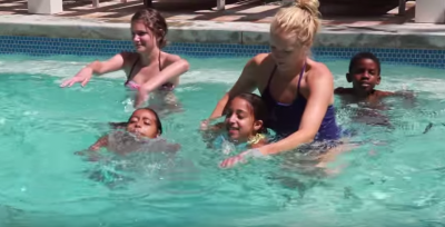 kids in a pool learning how to swim