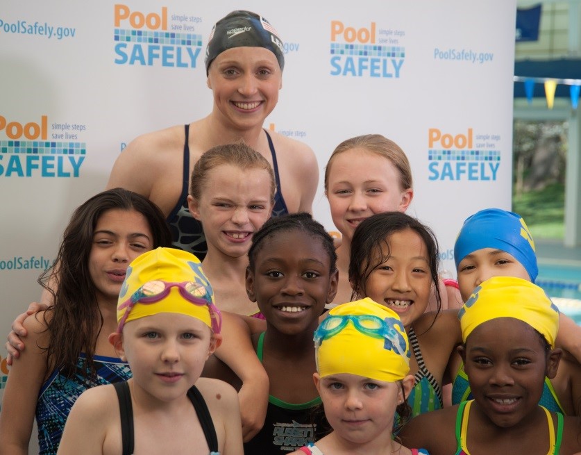 Katie Ledecky with a group of young swimmers.