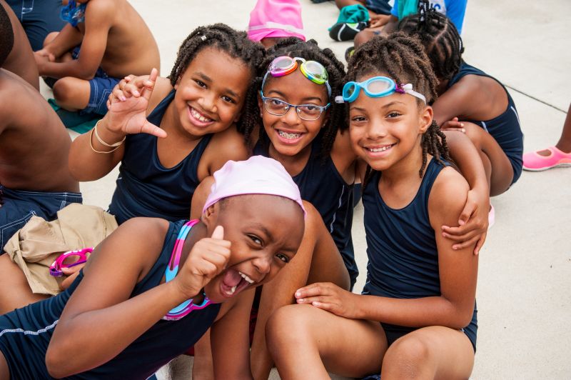 4 girls smiling before swim lessons