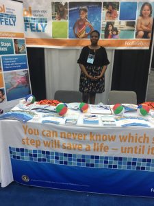 Women standing in front of a Pool Safely table