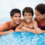 A cheerful family in a swimming pool.