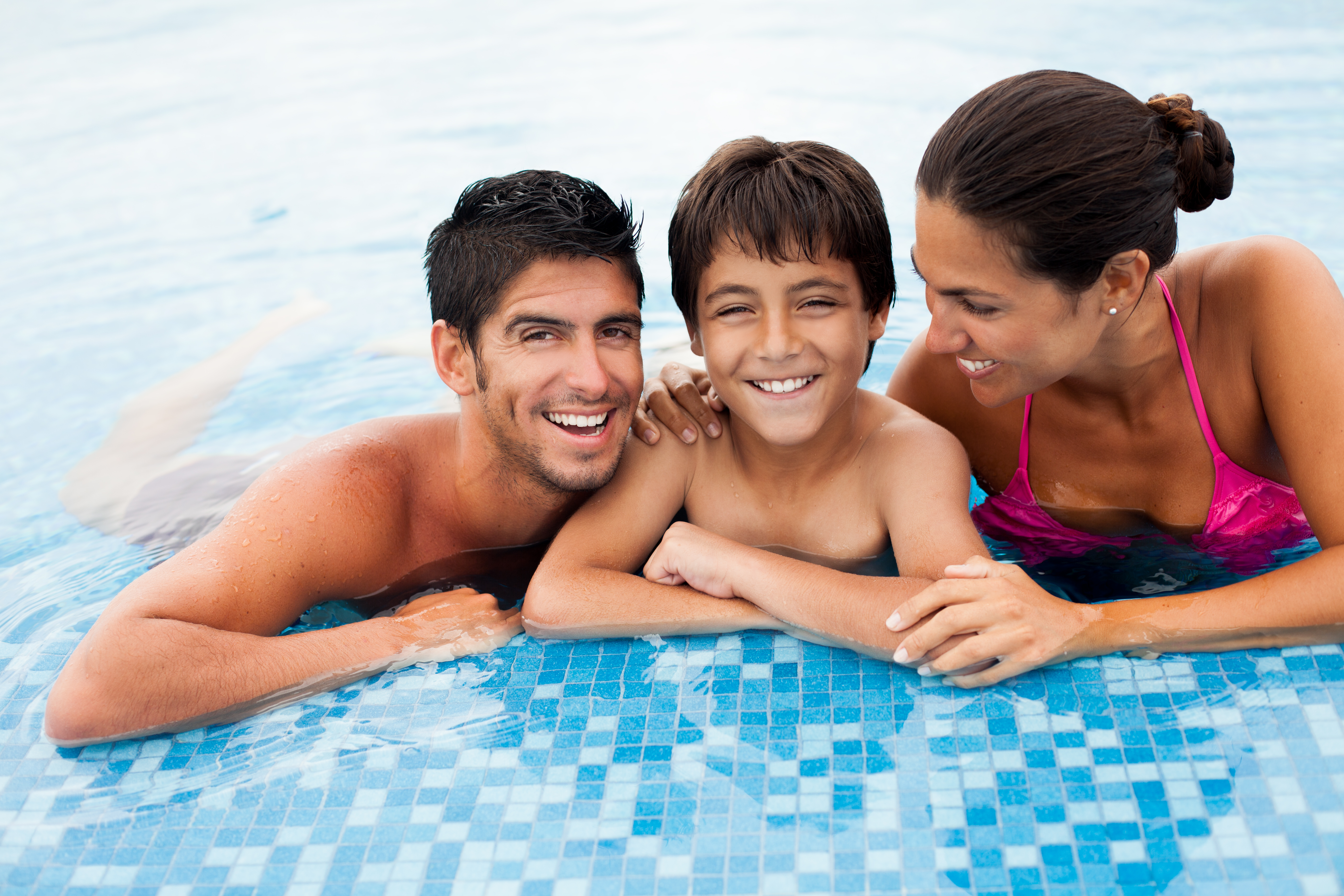 A cheerful family in a swimming pool.