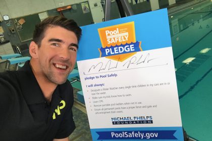 Michael Phelps selfie in front of his Pool Safely Pledge