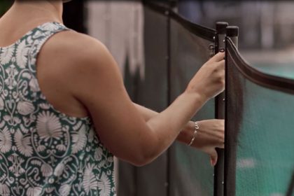 a woman interacting with a pool fence