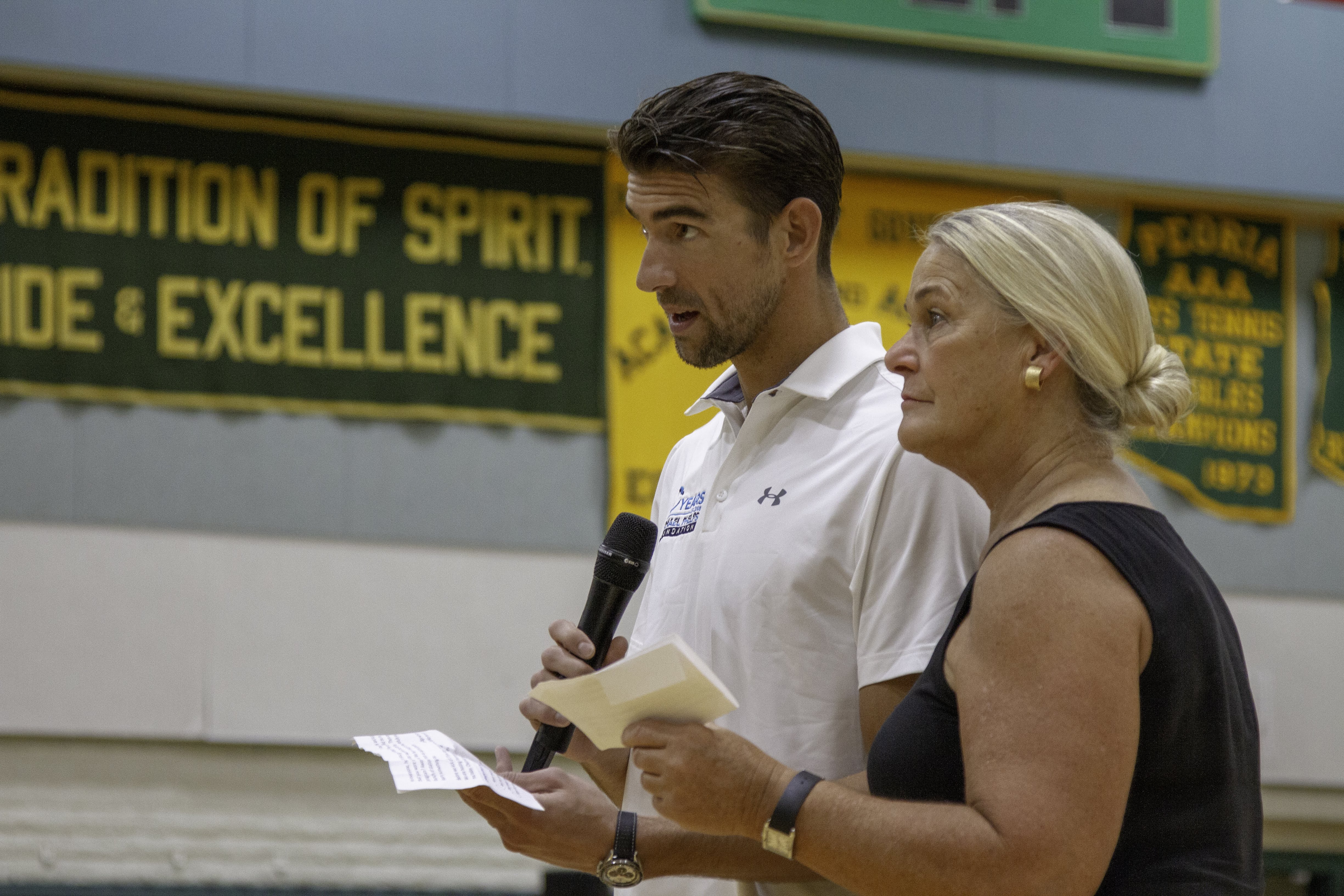 michael phelps and a woman speaking.