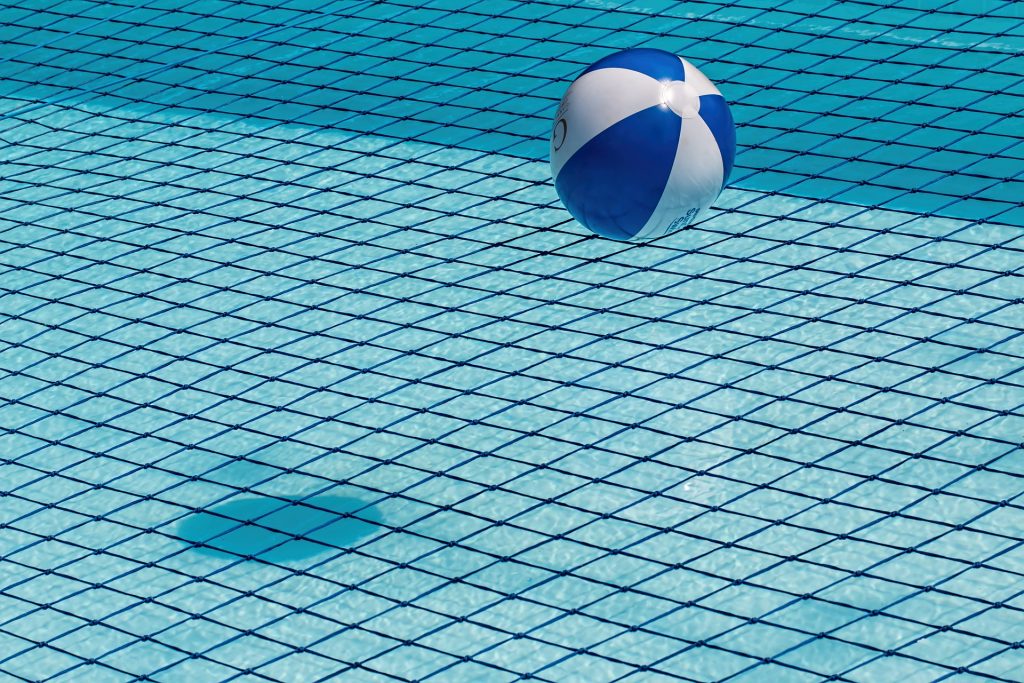 beach ball on a pool net.