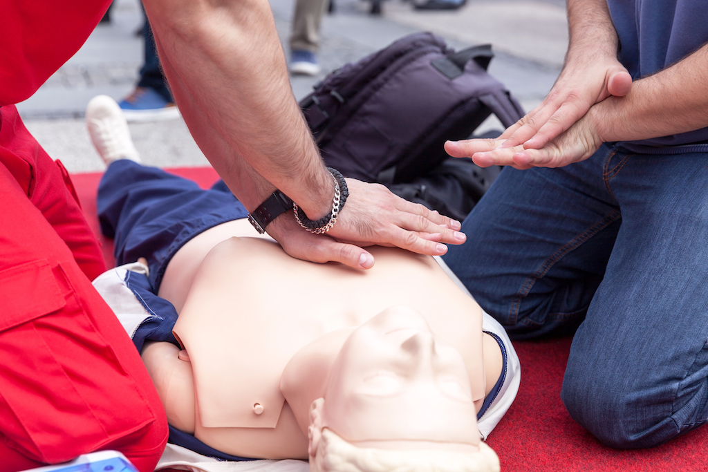 Instructor Teaching Cpr On Dummy