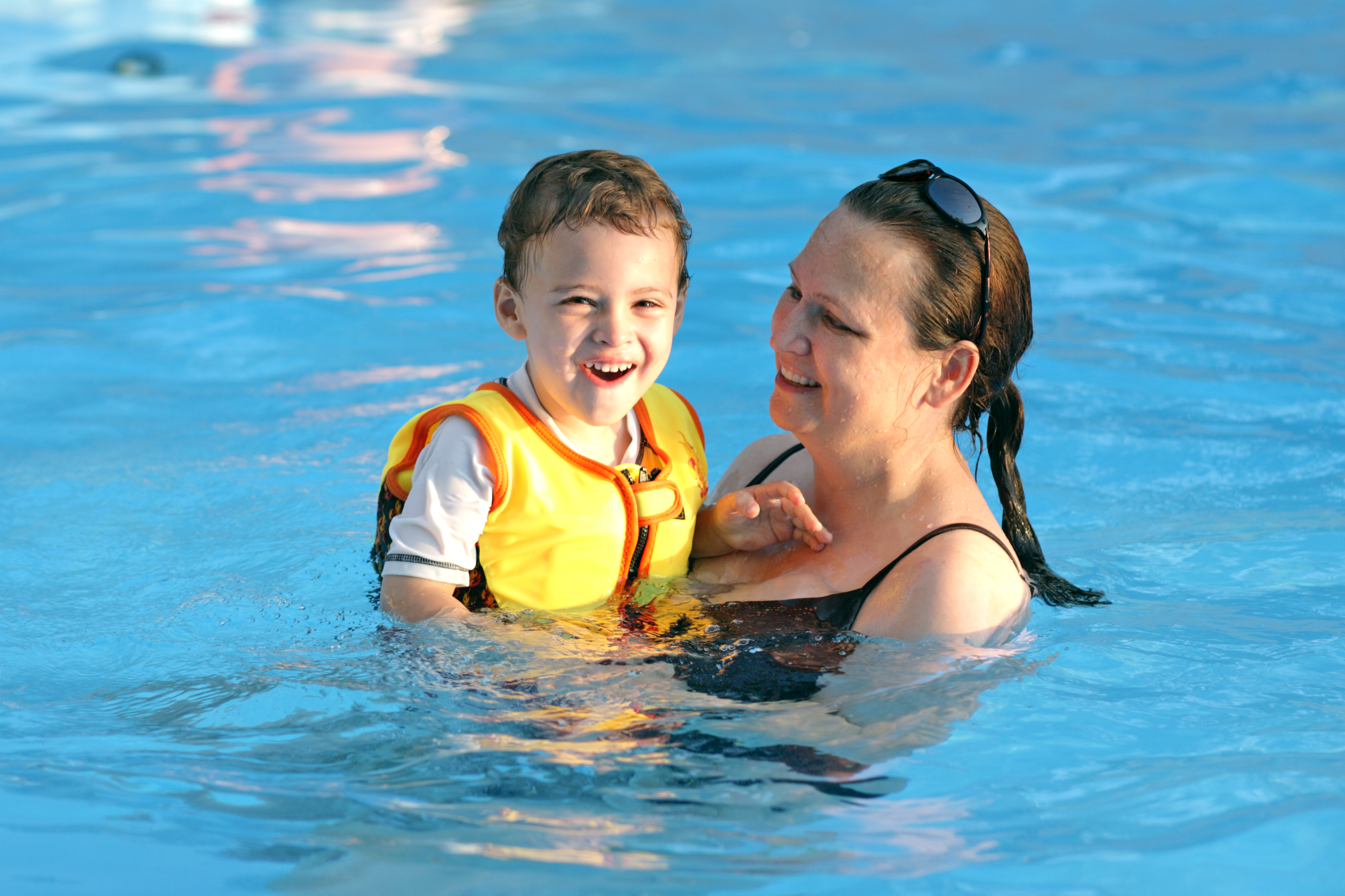 Mom swimming with autistic son