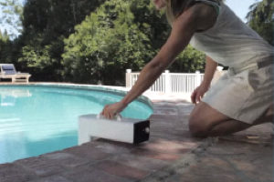 a woman installing a pool alarm.