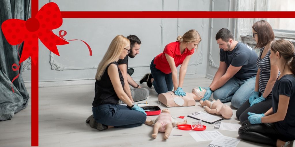 a group of young adults learning CPR.