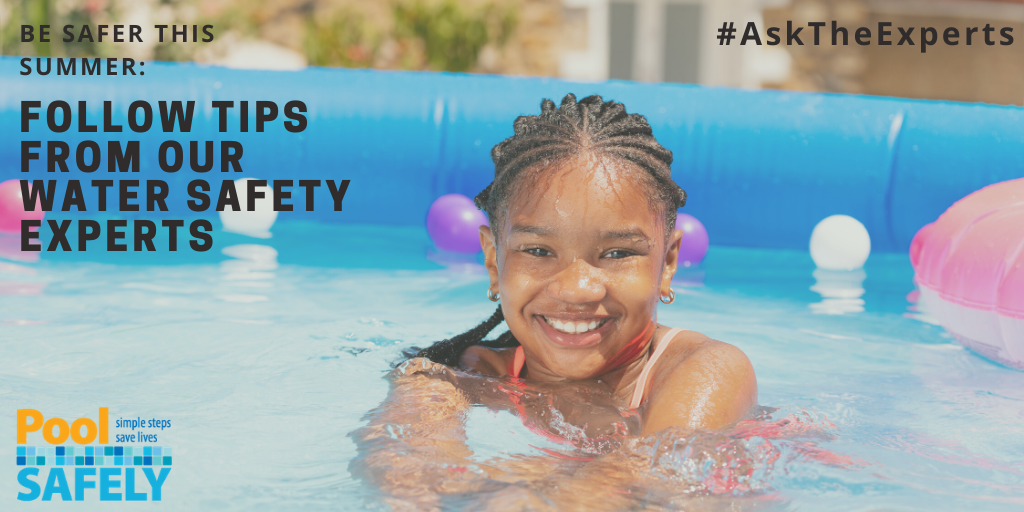 closeup of a child smiling to camera in a pool.