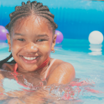 closeup of a young girl in an inflatable pool.