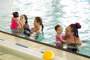 kids learning to swim in a pool